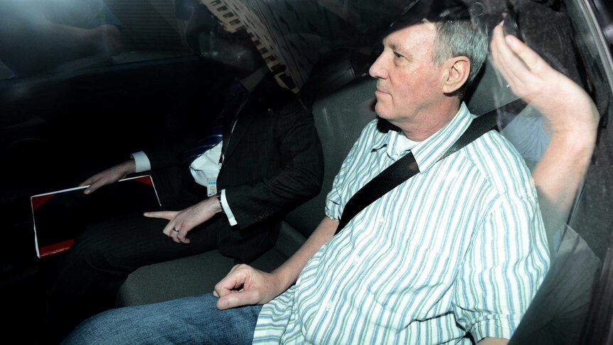 Robert Hughes is driven to the Central Local Court after being extradited to Australia from the UK.