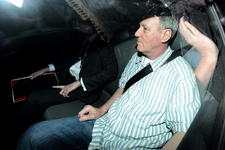Robert Hughes is driven to the Central Local Court after being extradited to Australia from the UK.