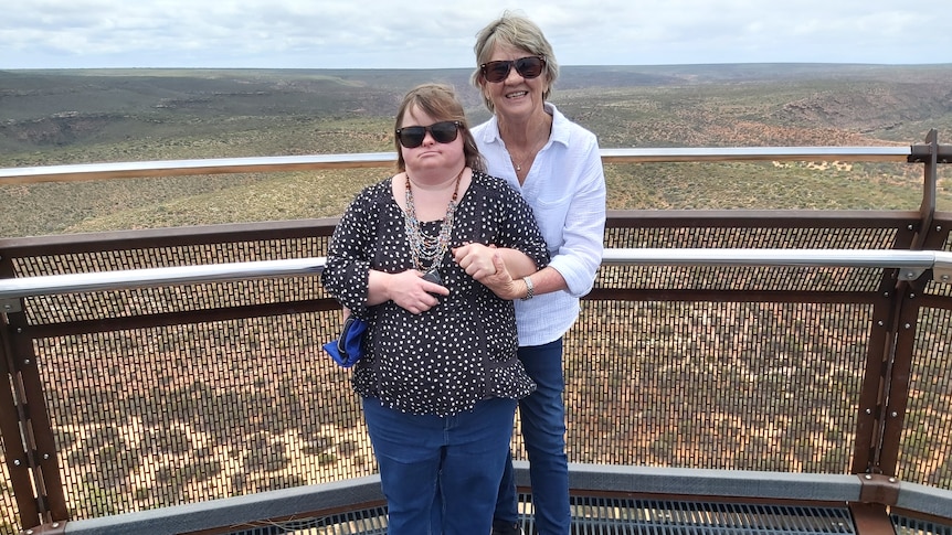 Gail embraces Sarah as they pose for a photo on a look out