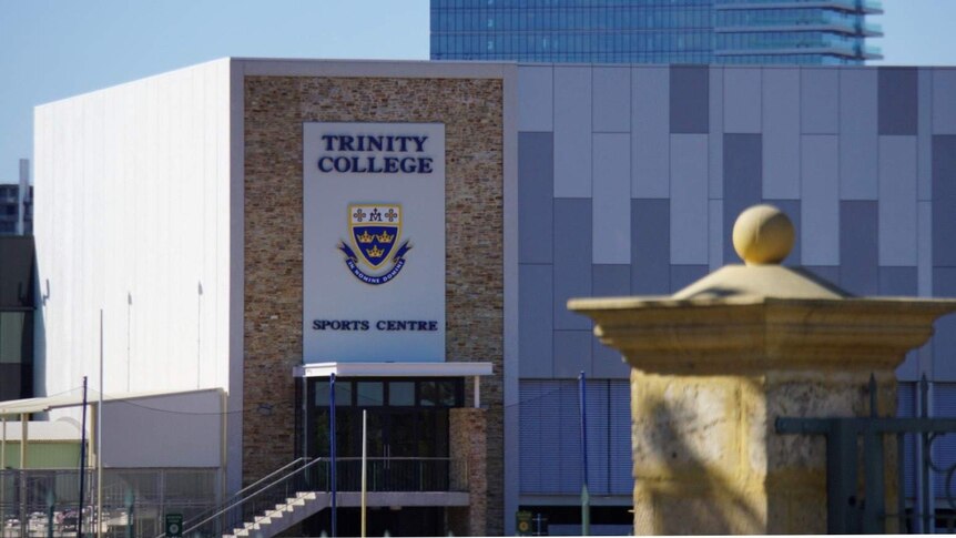 A long shot of the sports centre at Trinity College in Perth with the school's crerst on the side of the building.