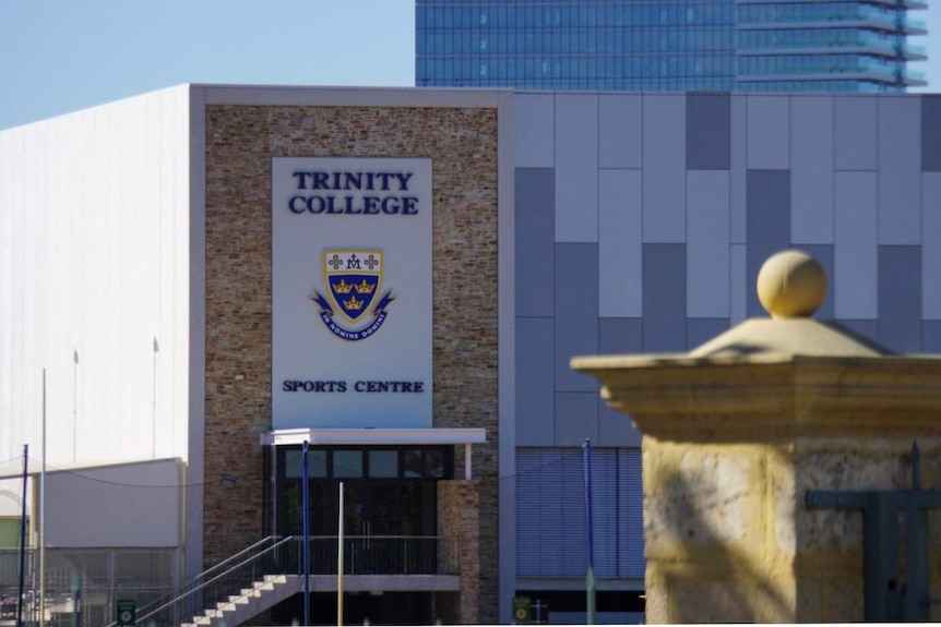 A long shot of the sports centre at Trinity College in Perth with the school's crerst on the side of the building.