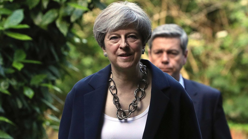 Britain's Prime Minister Theresa May arrives to attend Holy Communion at St Andrew's Church in Berkshire.