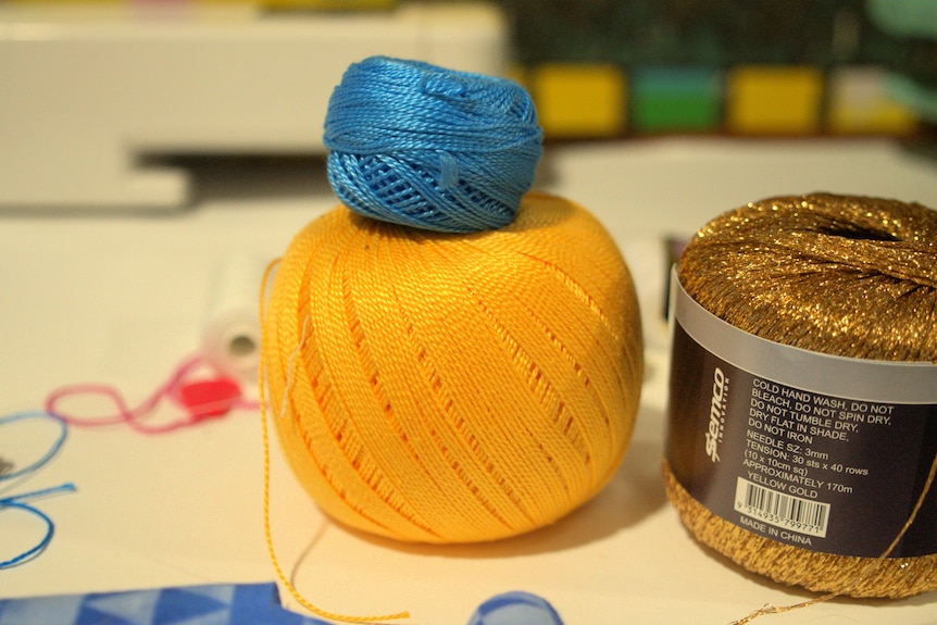 Blue, yellow, and gold thread.