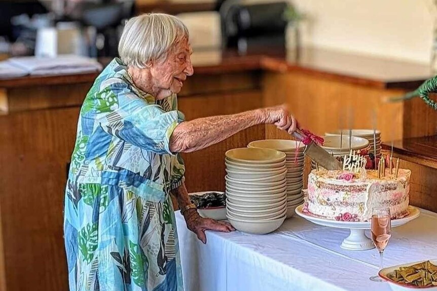 100 year old cuts cake