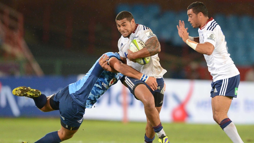 The Blues' Charles Piutau is tackled by the Bulls' Handre Pollard at Loftus Versfeld.