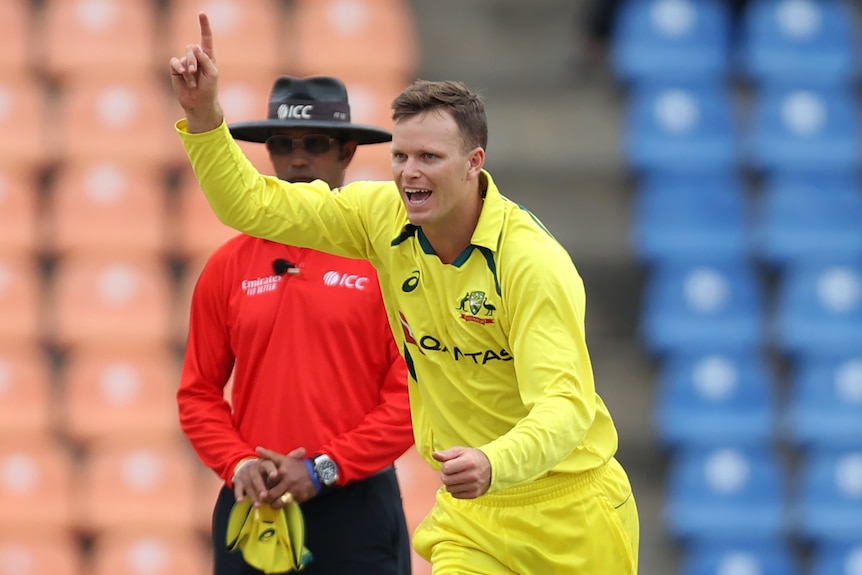 An Australian male ODI player raises a finger as he celebrates a wicket against Sri Lanka.