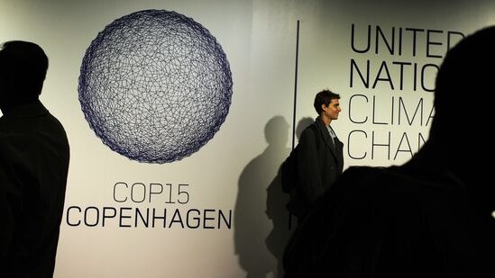 People pose and photograph the COP15 Copenhagen logo