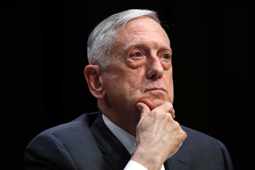 James Mattis sits with hand holding chin, looking outwards.