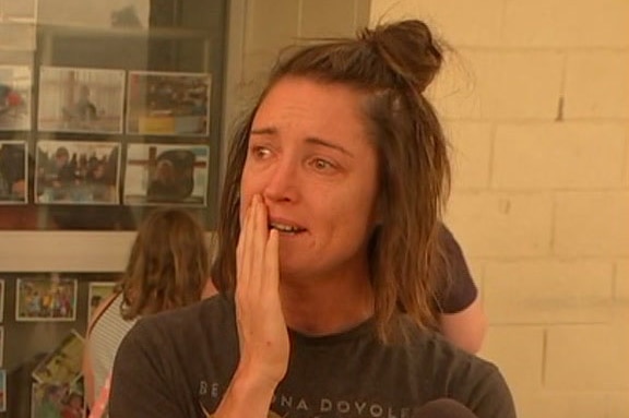 Amy Paton crying outside an evacuation centre.