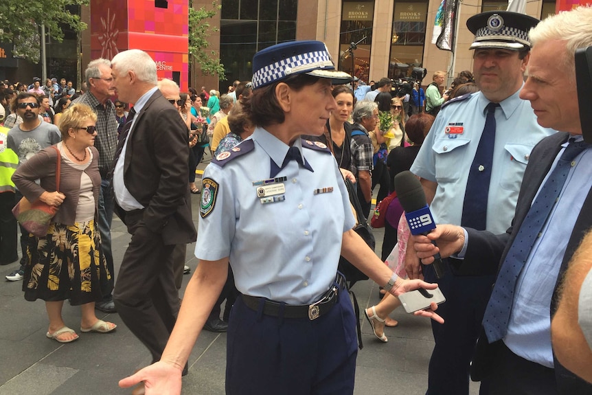 NSW Police Deputy Commissioner with her mobile phone on the day after the Sydney siege.