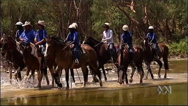 Indigenous teenagers ride horses