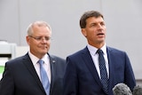 Angus Taylor speaks to media as PM Scott Morrison looks on from behind
