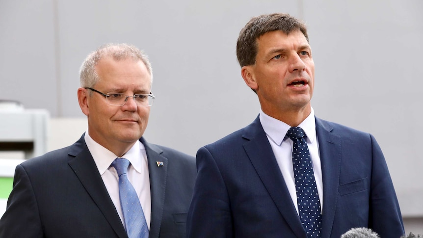 Angus Taylor speaks to media as PM Scott Morrison looks on from behind