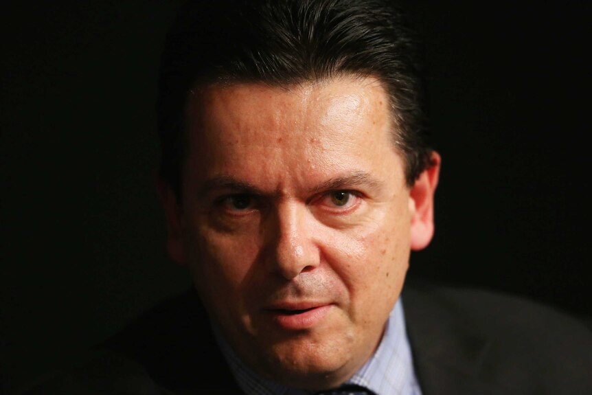 A close-op portrait of Senator Xenophon, surrounded by a black background.