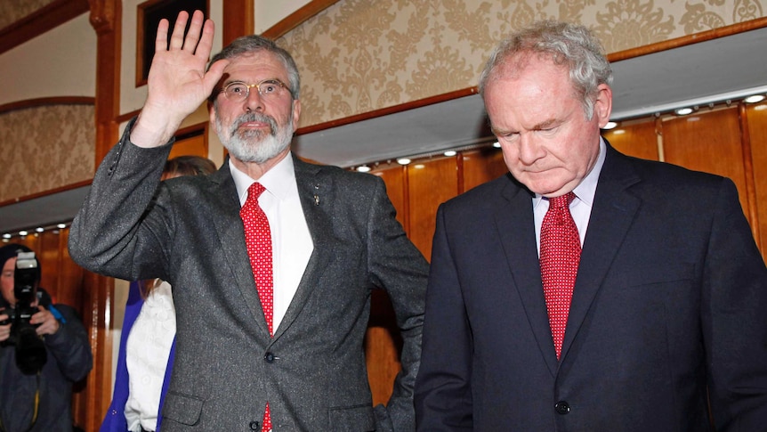 Republican party Sinn Fein leader Gerry Adams (L) waves to supporters.