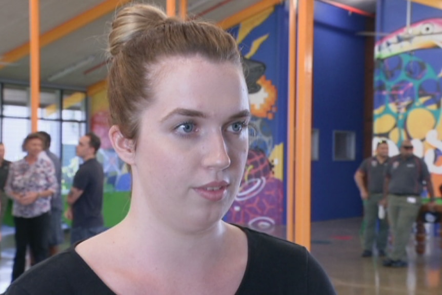 Woman standing in front of a group in a recreation hall at Don Dale youth detention centre.