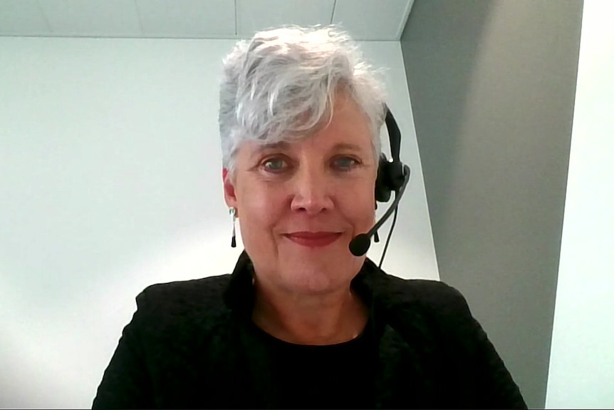 a woman wearing a headset looking down