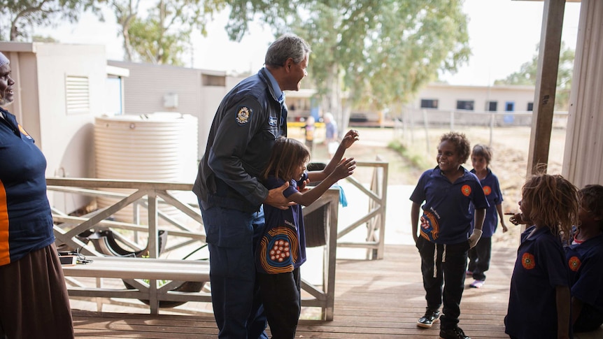 Warakurna police officers Wendy Kelly and Revis Ryder stop to chat with locals at the school.