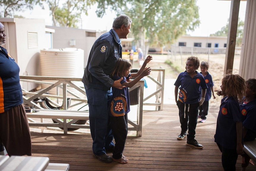 Warakurna police officers Wendy Kelly and Revis Ryder stop to chat with locals at the school.