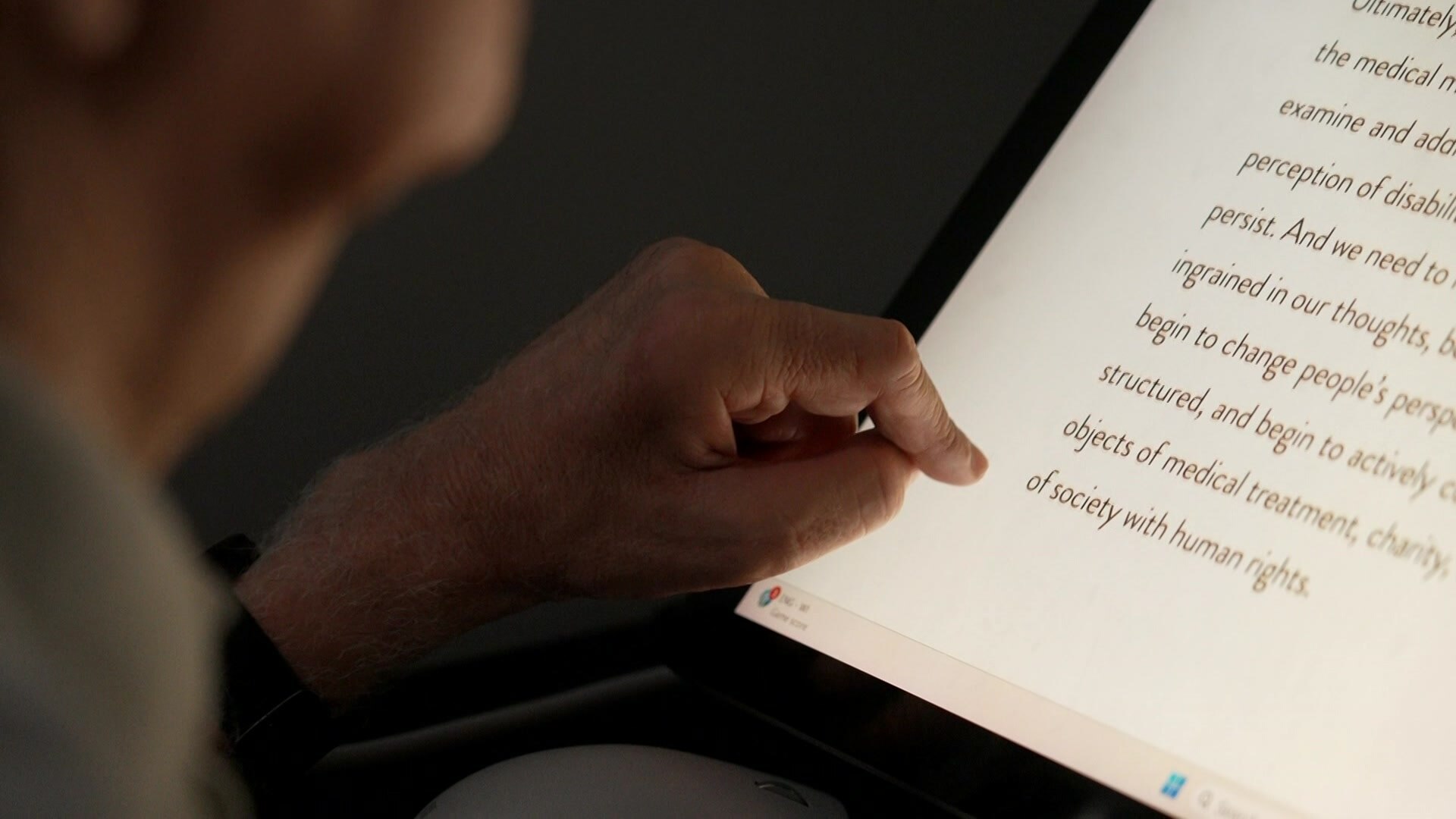 A close up of a hand using a tablet computer