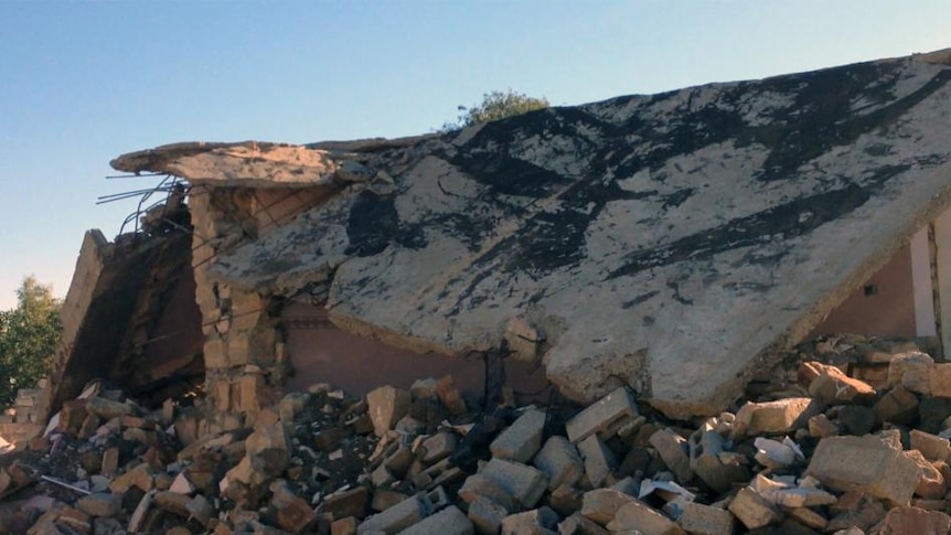 Several bricks among the remains of bulldozed buildings.