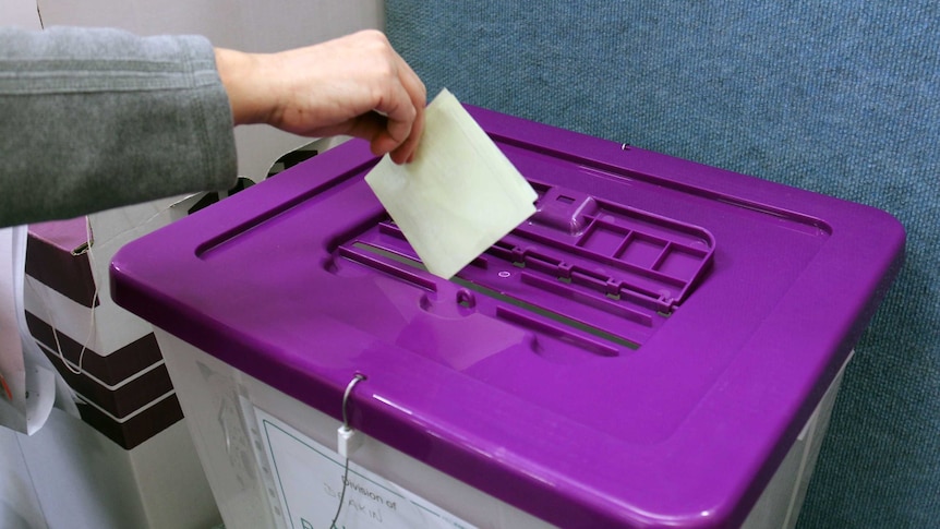 House of Reps ballot going into ballot box at pre-polling station