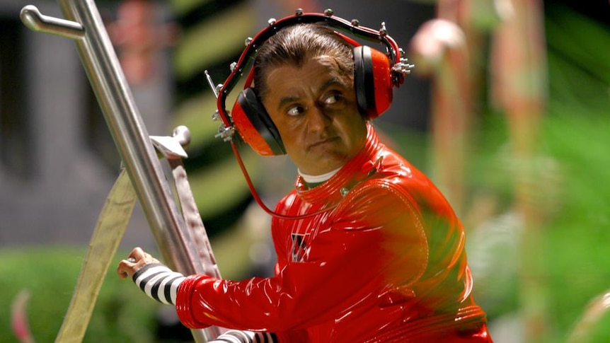 Deep Roy in his bright red Oompa Loompa costume in Tim Burton's Charlie and the Chocolate Factory.