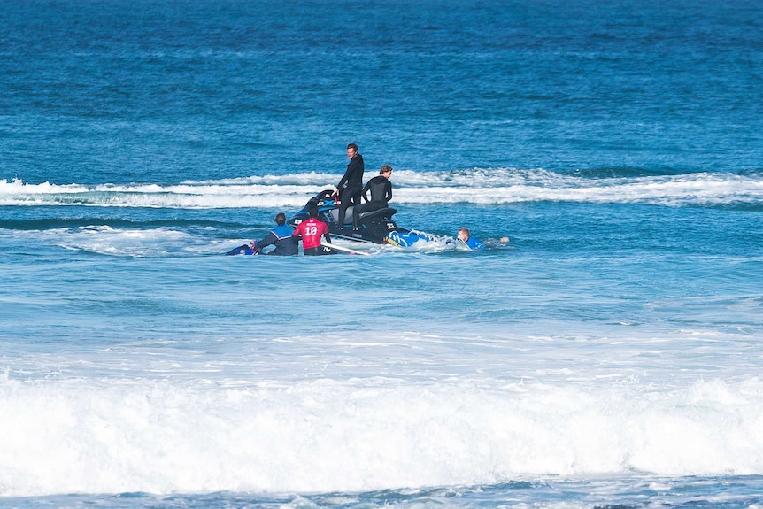 Mick Fanning and Gabriel Medina climb onto jet skis in Jeffreys Bay