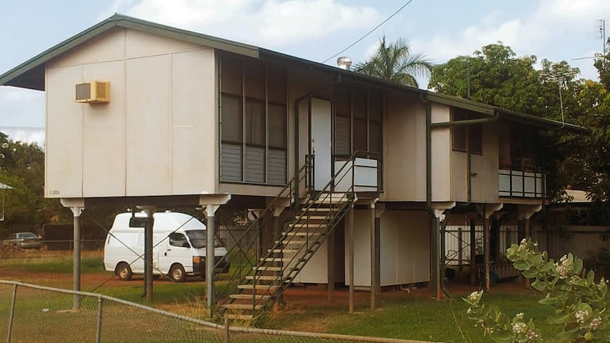 A house on stilts in the suburbs.