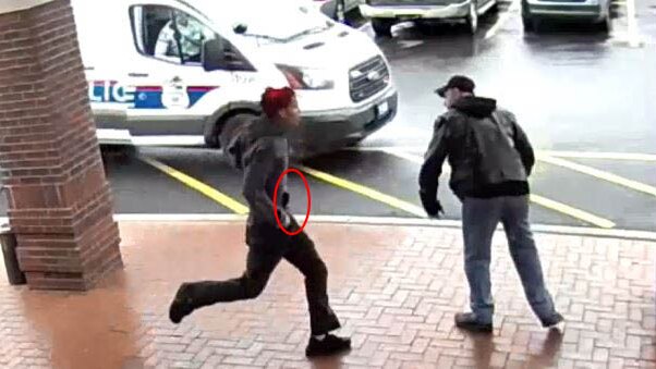 A red circle marks where a handgun is visible in the assailants waistband.