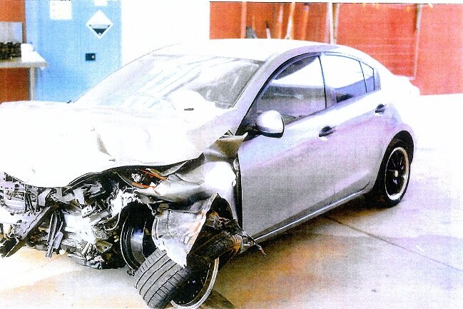 The front-end of a Mazda 3 is significantly damaged.