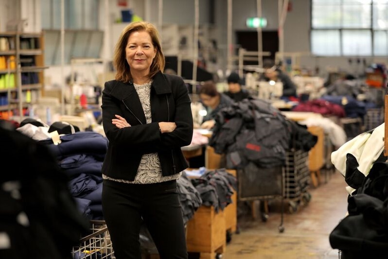 ACTU President Michele O'Neil stands in front of a pile of garments