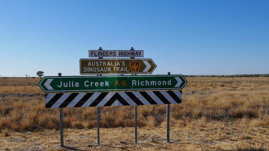A road sign showing the way to Julia Creek and Richmond.