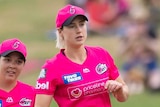 Ellyse Perry (centre) and Lauren Smith (left) of the Sydney Sixers celebrate a WBBL wicket with teammates.