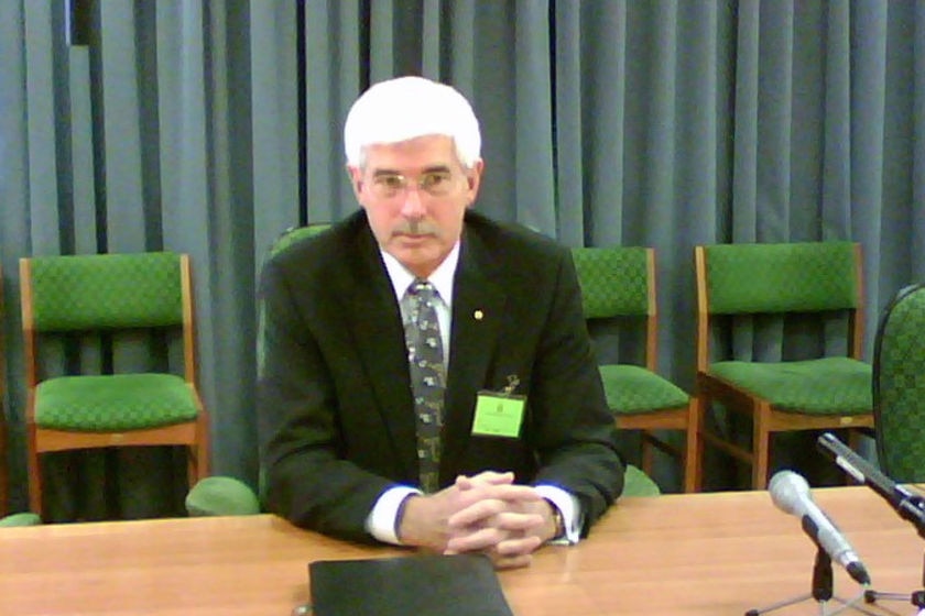 A man sits at a desk. 