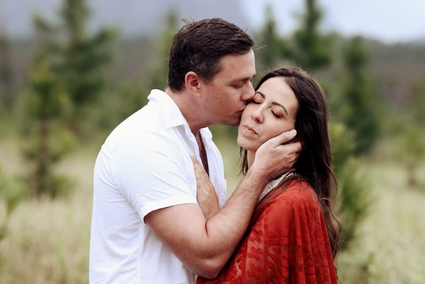A man kissing a woman on the cheek
