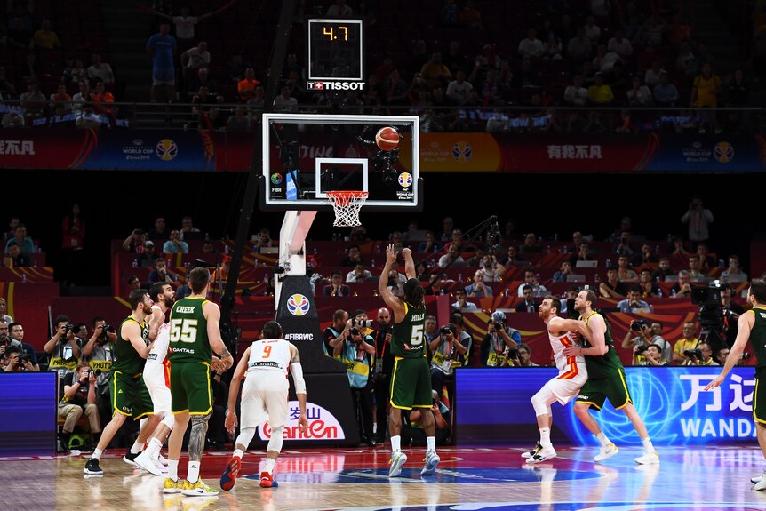 Seen from behind, Patty Mills shoots a free throw with 4.7 seconds left in Australia's 2019 World Cup semifinal against Spain.