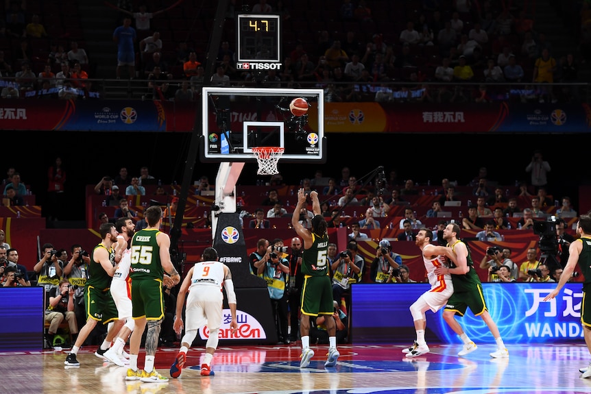 Seen from behind, Patty Mills shoots a free throw with 4.7 seconds left in Australia's 2019 World Cup semifinal against Spain.