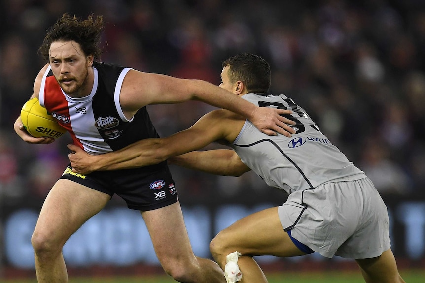 Jack Steven attempts to beat the tackle of  Ed Curnow.