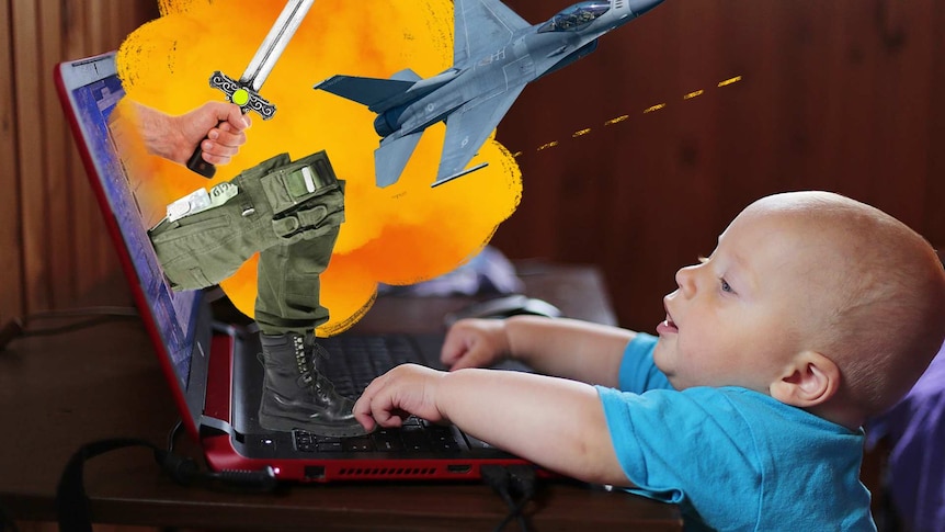 Baby is reaching to play with the computer
