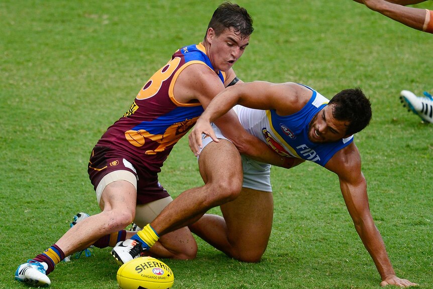Brisbane's Tom Rockliff tackles Gold Coast's Karmichael Hunt