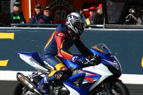 A man on a racing motorcycle.
