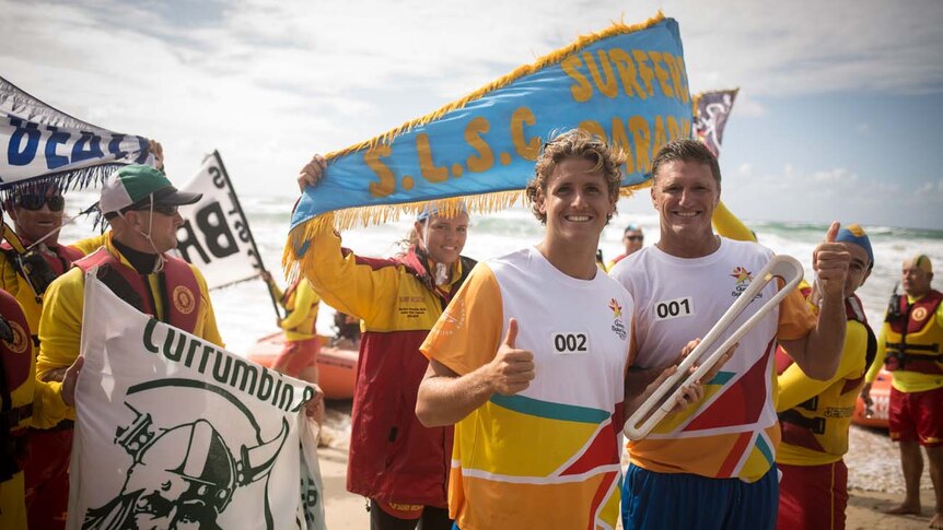 Surf lifesavers with the Queen's Baton ahead of the Commonwealth Games on the Gold Coast