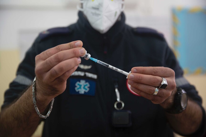 An Israeli medic prepares a Pfizer-BioNTech COVID vaccine