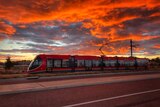 A light-rail vehicle during sunset.