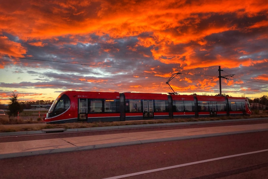A light-rail vehicle during sunset.