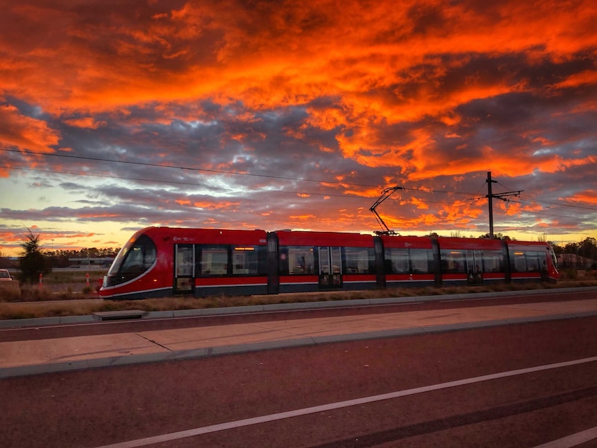 A light-rail vehicle during sunset.