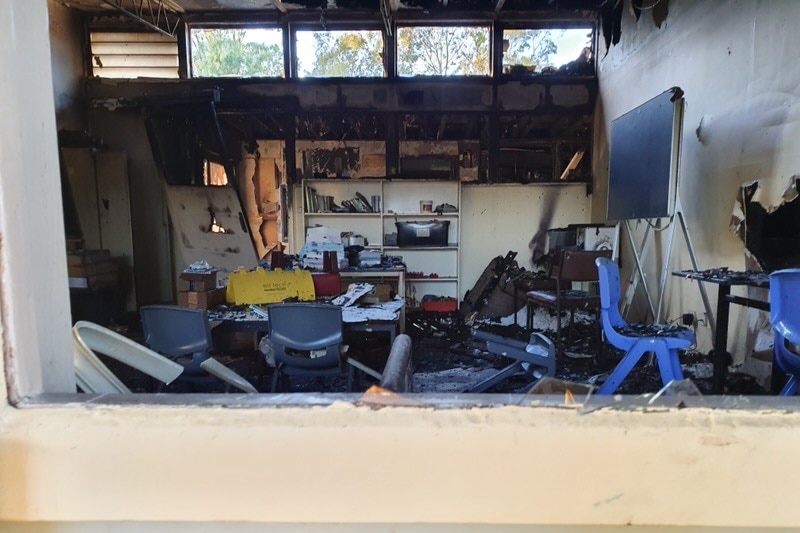 The inside of a burnt classroom. Debris is everywhere.