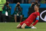 Portugal attacker Cristiano Ronaldo slides on his knees across grass