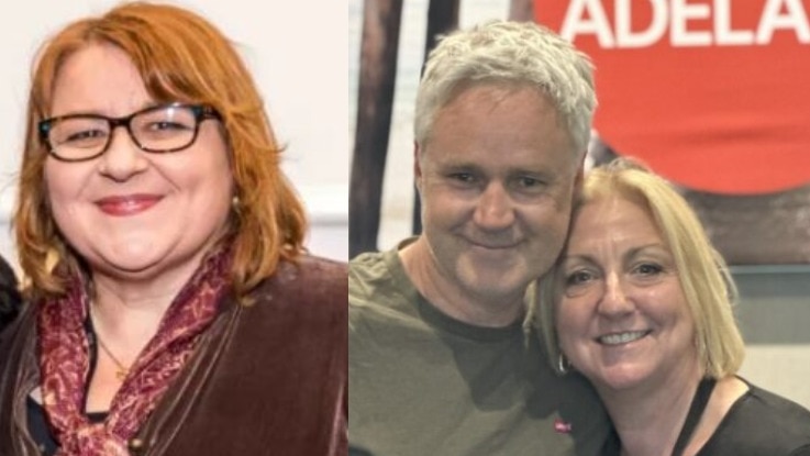 woman with red hair and spectacles smiling and man with grey hair and woman with blonde hair shoulder-to-shoulder smiling